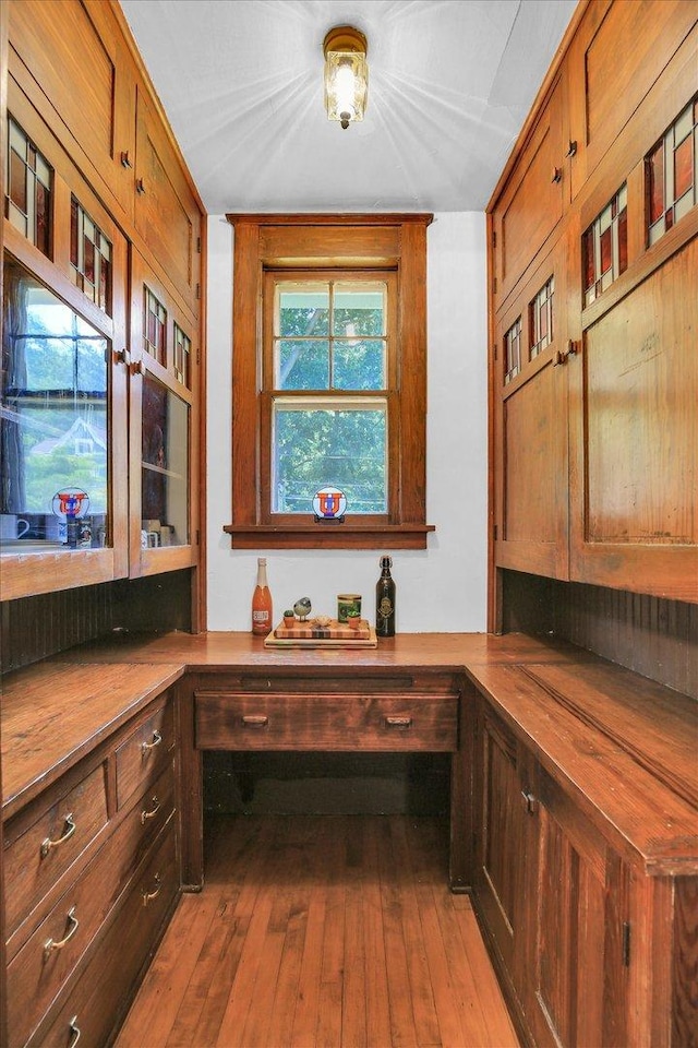 310 Davidson Dr, Champaign, IL 61821 - kitchen featuring built in desk, wooden counters, hardwood / wood-style flooring, and brown cabinetry