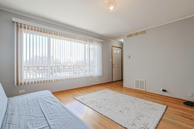 4925 N Harlem Ave Unit 3, Chicago, IL 60656 - bedroom featuring crown molding, wood finished floors, and baseboards