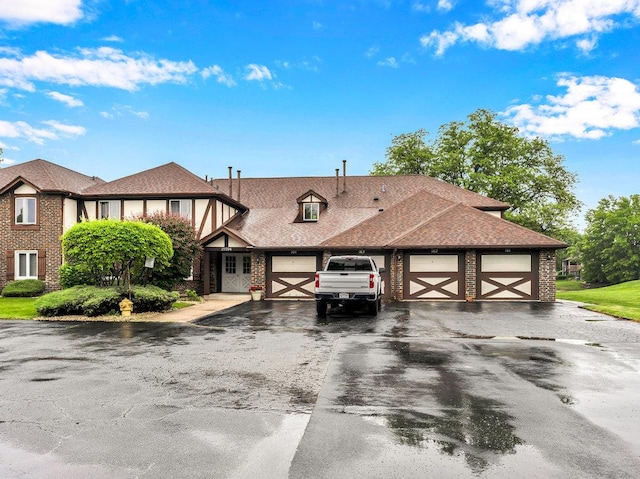 15704 Orlan Brook Dr Unit 163, Orland Park, IL 60462 - tudor house featuring an attached garage, asphalt driveway, brick siding, and a shingled roof