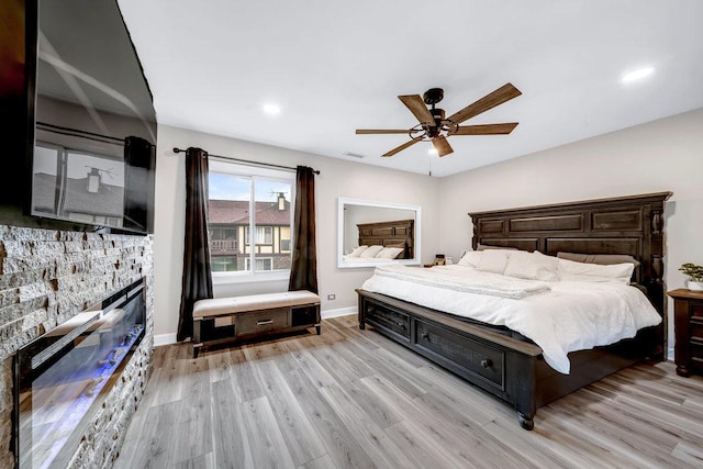 15704 Orlan Brook Dr Unit 163, Orland Park, IL 60462 - bedroom with a stone fireplace, light wood finished floors, recessed lighting, ceiling fan, and baseboards