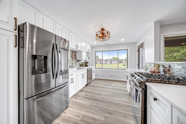 15704 Orlan Brook Dr Unit 163, Orland Park, IL 60462 - kitchen featuring stainless steel appliances, a sink, backsplash, white cabinetry, and light wood-type flooring