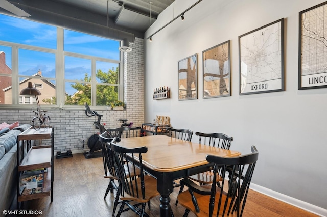 2750 N Wayne Ave Unit G, Chicago, IL 60614 - dining room featuring brick wall, wood finished floors, and baseboards