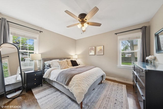 710 Western Ave, Glen Ellyn, IL 60137 - bedroom featuring a baseboard heating unit, dark wood finished floors, baseboards, and ceiling fan