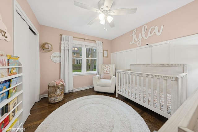 710 Western Ave, Glen Ellyn, IL 60137 - bedroom with a crib, a baseboard heating unit, wood finished floors, ceiling fan, and a closet