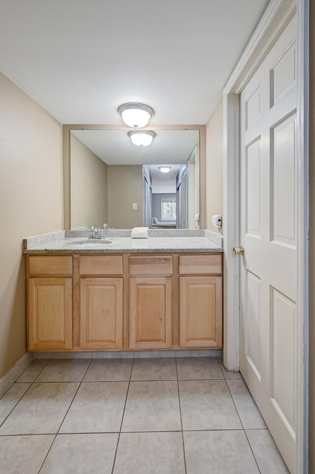 1640 Royal Oak Rd Unit 4, Darien, IL 60561 - bathroom with vanity, tile patterned flooring, and baseboards