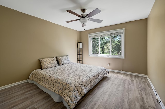 1640 Royal Oak Rd Unit 4, Darien, IL 60561 - bedroom featuring baseboards, wood finished floors, and a ceiling fan