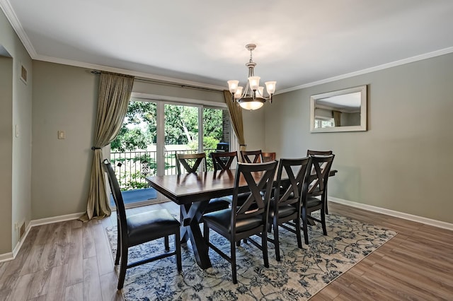 1640 Royal Oak Rd Unit 4, Darien, IL 60561 - dining room featuring ornamental molding, a chandelier, baseboards, and wood finished floors