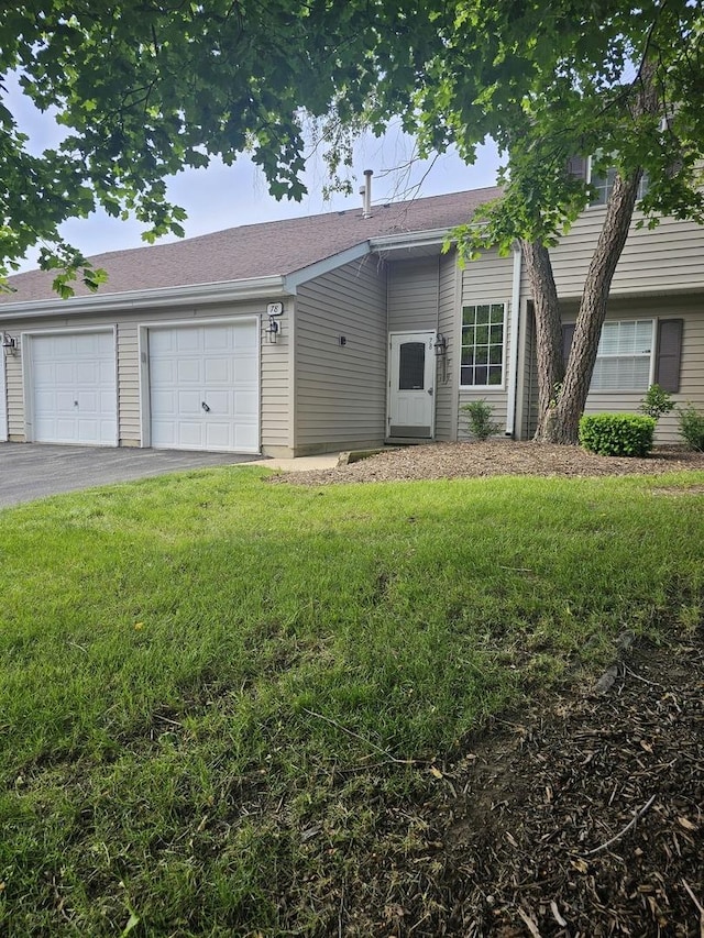 78 N Victoria Ln Unit F, Streamwood, IL 60107 - view of front of house featuring a garage, driveway, and a front lawn