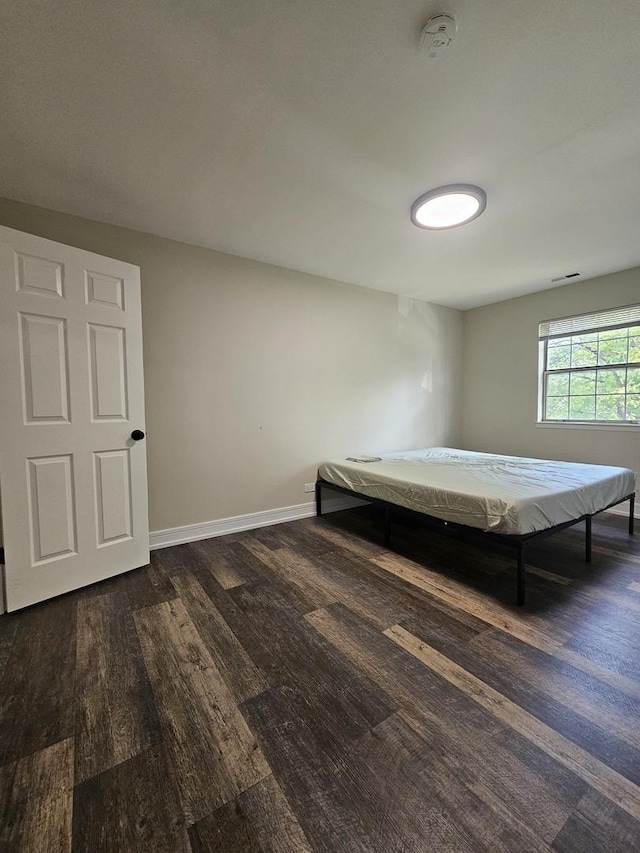 78 N Victoria Ln Unit F, Streamwood, IL 60107 - bedroom with dark wood-type flooring and baseboards