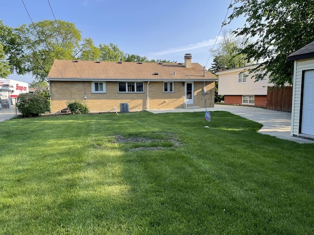 2068 David Dr, Des Plaines, IL 60018 - rear view of house with a chimney, a yard, brick siding, and cooling unit