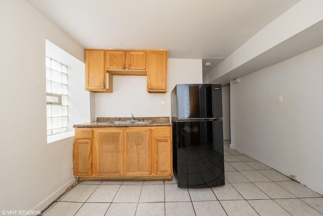 1831 S Avers Ave, Chicago, IL 60623 - kitchen featuring freestanding refrigerator, a sink, light tile patterned flooring, dark countertops, and baseboards
