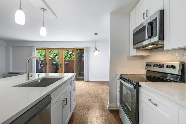 1115 S Plymouth Ct Unit 102, Chicago, IL 60605 - kitchen with appliances with stainless steel finishes, a sink, dark wood-type flooring, backsplash, and white cabinets