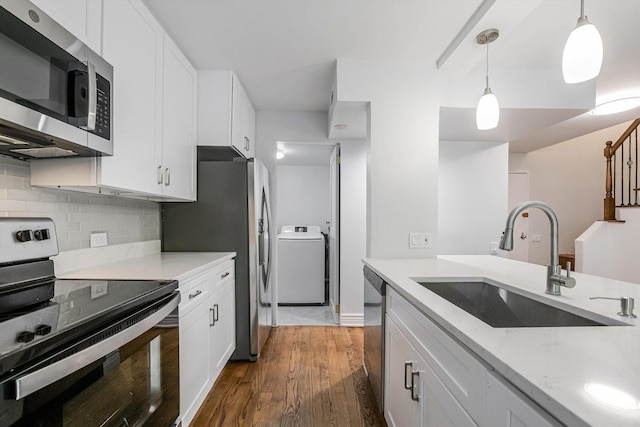 1115 S Plymouth Ct Unit 102, Chicago, IL 60605 - kitchen featuring appliances with stainless steel finishes, washer / dryer, a sink, dark wood finished floors, and white cabinets