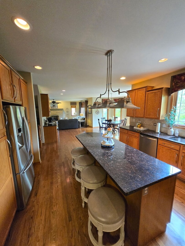 10880 Swallow Tail Ln, Frankfort, IL 60423 - kitchen with appliances with stainless steel finishes, brown cabinets, dark wood-style floors, and recessed lighting