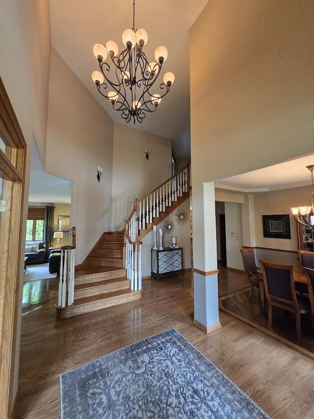 10880 Swallow Tail Ln, Frankfort, IL 60423 - foyer entrance featuring a chandelier, high vaulted ceiling, wood finished floors, stairway, and baseboards