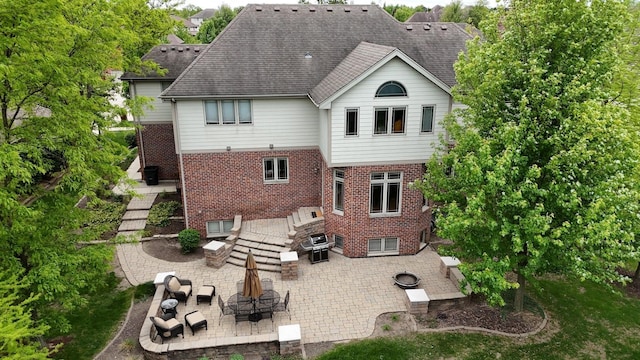 10880 Swallow Tail Ln, Frankfort, IL 60423 - rear view of property with brick siding, a patio area, an outdoor fire pit, and outdoor dining area