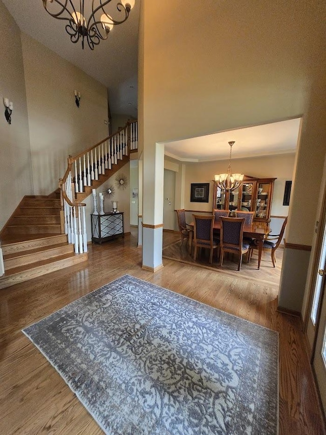 10880 Swallow Tail Ln, Frankfort, IL 60423 - foyer featuring a chandelier, stairway, wood finished floors, and baseboards