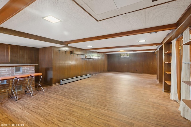 4N312 Kenwood Ave, West Chicago, IL 60185 - basement featuring a baseboard heating unit, wooden walls, light wood-type flooring, and a dry bar
