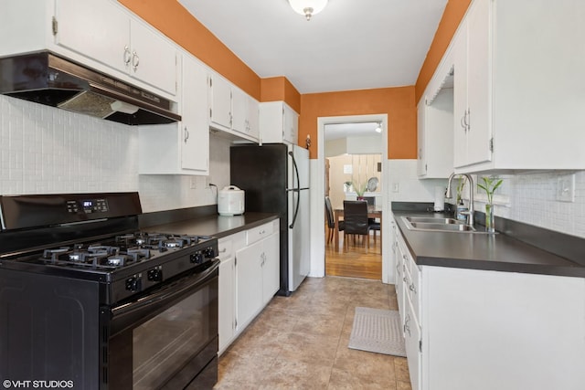 4N312 Kenwood Ave, West Chicago, IL 60185 - kitchen with black range with gas stovetop, under cabinet range hood, a sink, dark countertops, and freestanding refrigerator