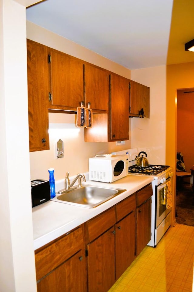 9820 S Pulaski Ave Unit 218, Oak Lawn, IL 60453 - kitchen with white appliances, a sink, light countertops, and brown cabinets