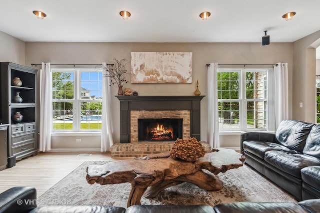 900 Legacy Rdg, Algonquin, IL 60102 - living room with light wood-type flooring, healthy amount of natural light, a fireplace, and arched walkways