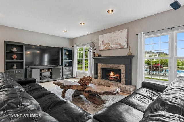 900 Legacy Rdg, Algonquin, IL 60102 - living area featuring wood finished floors and a brick fireplace