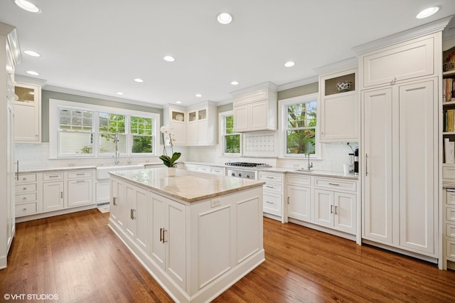 739 Forest Ave, Evanston, IL 60202 - kitchen featuring a sink, decorative backsplash, white cabinets, stainless steel gas cooktop, and crown molding