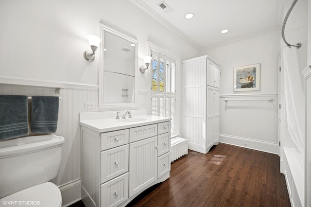 739 Forest Ave, Evanston, IL 60202 - bathroom with crown molding, vanity, wood finished floors, a wainscoted wall, and toilet