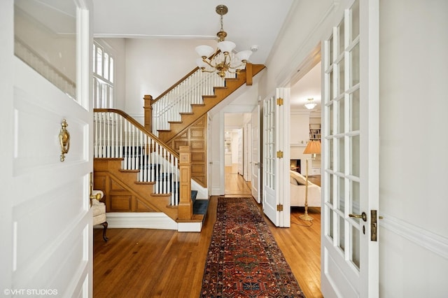 739 Forest Ave, Evanston, IL 60202 - foyer featuring french doors, a chandelier, wood finished floors, and stairway