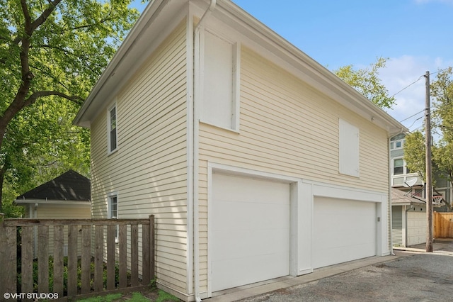 739 Forest Ave, Evanston, IL 60202 - view of side of property with an attached garage and asphalt driveway