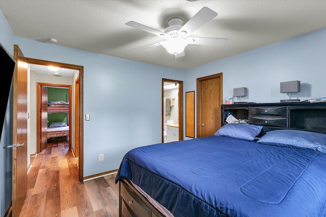 1803 Oliver Dr Unit 3, Urbana, IL 61802 - bedroom with wood finished floors, baseboards, ceiling fan, and connected bathroom