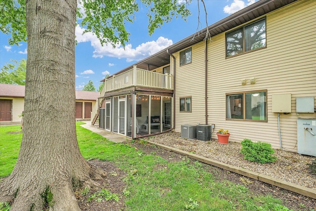 1803 Oliver Dr Unit 3, Urbana, IL 61802 - rear view of house with a balcony, central air condition unit, a sunroom, and a lawn