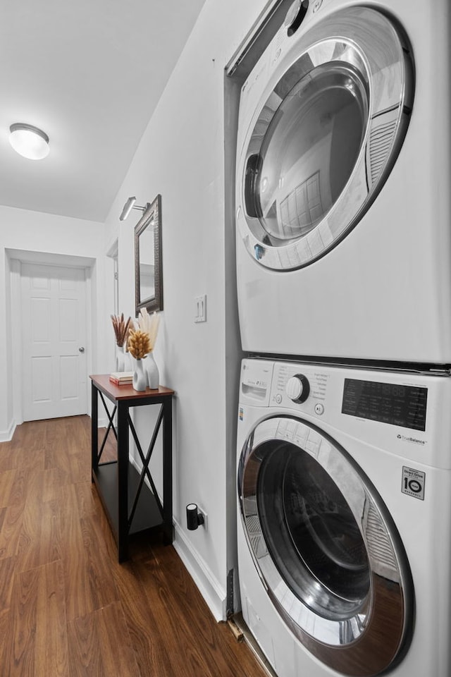 4755 N Malden St Unit Gs, Chicago, IL 60640 - laundry area featuring stacked washer / drying machine, dark wood-style floors, and baseboards
