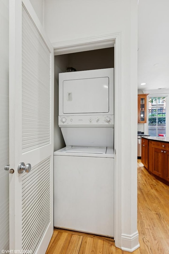 3717 N Wilton Ave Unit 1, Chicago, IL 60613 - washroom with stacked washer / dryer and light wood finished floors