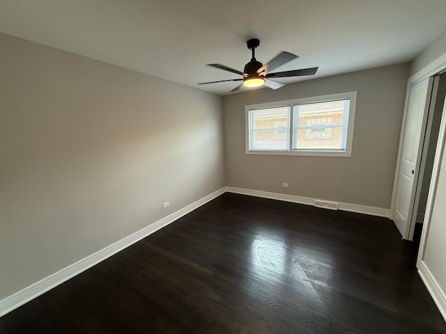 3906 W 117th St, Alsip, IL 60803 - unfurnished bedroom featuring dark wood-style flooring, a closet, and a ceiling fan