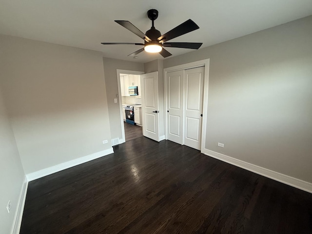 3906 W 117th St, Alsip, IL 60803 - unfurnished bedroom with dark wood-style flooring, a closet, and ceiling fan