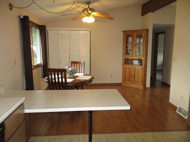 402 Heritage Ln, Ottawa, IL 61350 - dining room featuring lofted ceiling, ceiling fan, wood finished floors, and baseboards