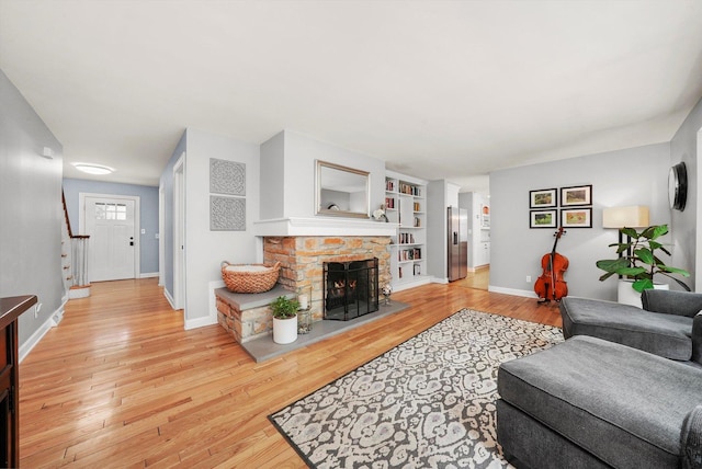 4N307 Knoll Creek Dr, Saint Charles, IL 60175 - living room featuring baseboards, light wood-style floors, a fireplace, and stairway
