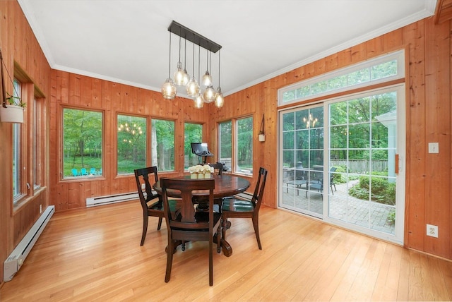 4N307 Knoll Creek Dr, Saint Charles, IL 60175 - dining space with a baseboard heating unit, crown molding, light wood-style flooring, wooden walls, and a chandelier