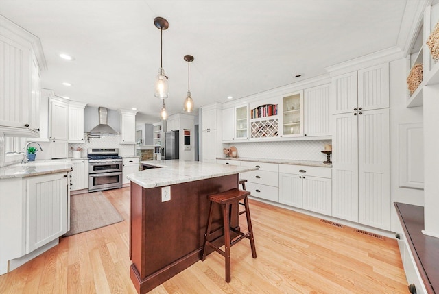 4N307 Knoll Creek Dr, Saint Charles, IL 60175 - kitchen featuring appliances with stainless steel finishes, wall chimney range hood, backsplash, light wood finished floors, and recessed lighting