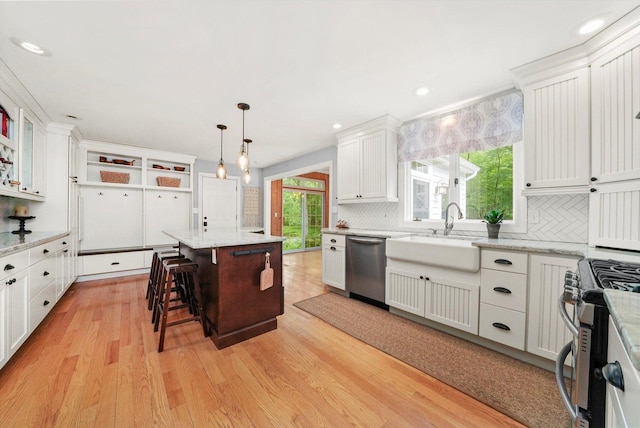 4N307 Knoll Creek Dr, Saint Charles, IL 60175 - kitchen with appliances with stainless steel finishes, light wood-style floors, backsplash, a sink, and white cabinets