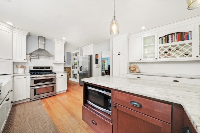 4N307 Knoll Creek Dr, Saint Charles, IL 60175 - kitchen with wall chimney exhaust hood, appliances with stainless steel finishes, decorative backsplash, glass insert cabinets, and recessed lighting