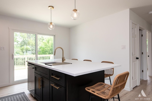 9058 Caddy Ct, Orland Park, IL 60462 - kitchen featuring a kitchen breakfast bar, light wood-style floors, light countertops, pendant lighting, and dark cabinets