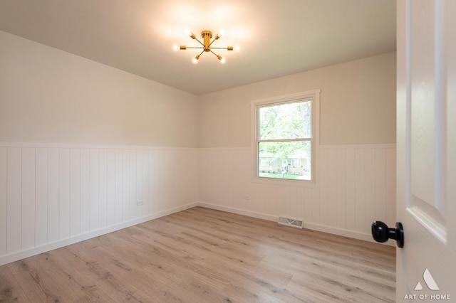 9058 Caddy Ct, Orland Park, IL 60462 - empty room with a chandelier, a wainscoted wall, and wood finished floors