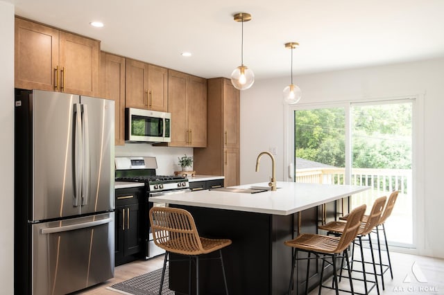 9058 Caddy Ct, Orland Park, IL 60462 - kitchen with stainless steel appliances, light countertops, a kitchen breakfast bar, a kitchen island with sink, and recessed lighting