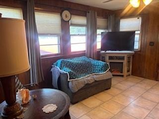 785 Alice St, Chicago Heights, IL 60411 - living room featuring ceiling fan, light tile patterned floors, and wood walls