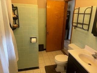 785 Alice St, Chicago Heights, IL 60411 - bathroom with tile walls, vanity, toilet, and tile patterned floors