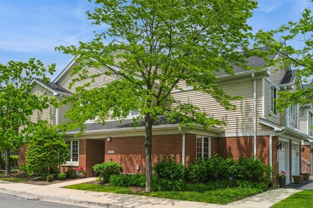 7410 Lincoln Ave Unit A, Skokie, IL 60076 - view of front facade with brick siding and an attached garage