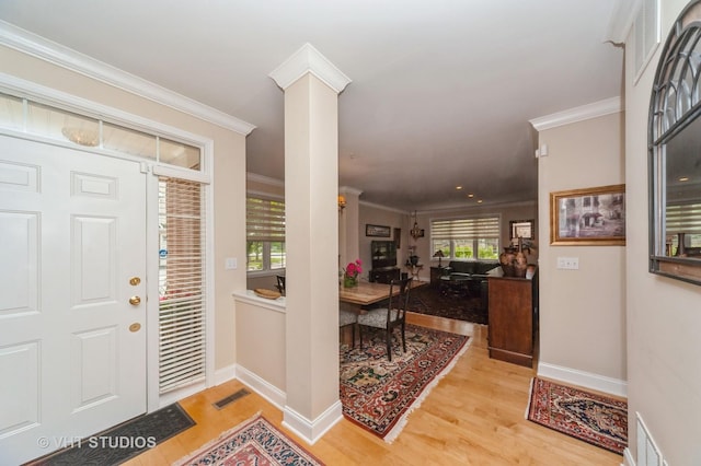 7410 Lincoln Ave Unit A, Skokie, IL 60076 - entrance foyer with wood finished floors, ornamental molding, baseboards, and ornate columns