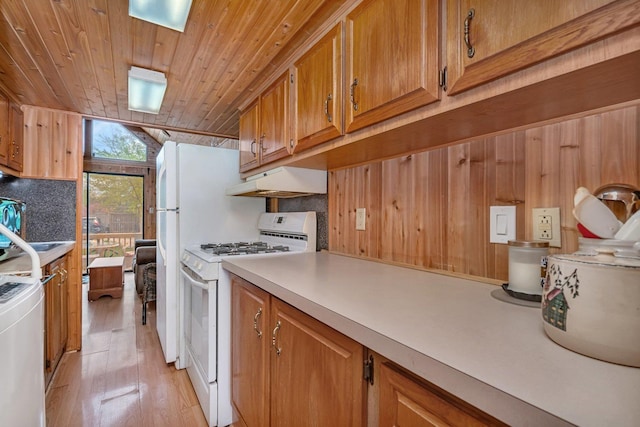 1 Dinosaur Rd, Wilmington, IL 60481 - kitchen featuring white range with gas cooktop, under cabinet range hood, washer / dryer, wooden ceiling, and light countertops